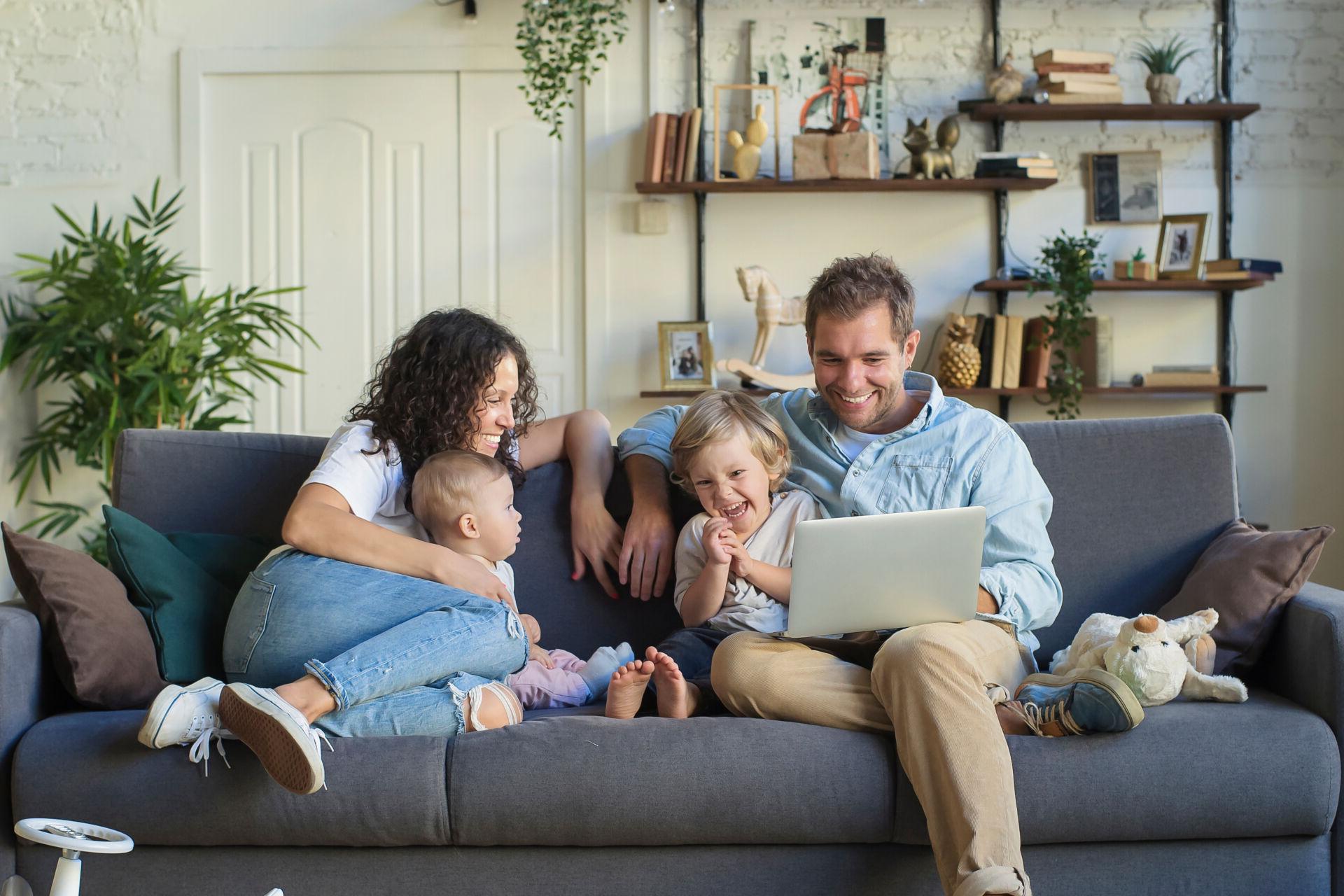 Young beautiful happy family relaxing at home